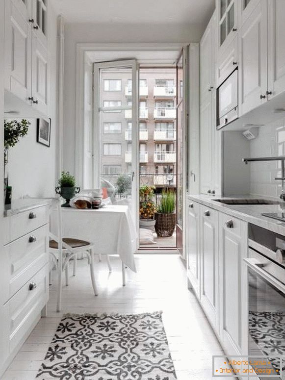 Weiße Küche im Innenraum - Foto einer kleinen Küche mit einem Balkon