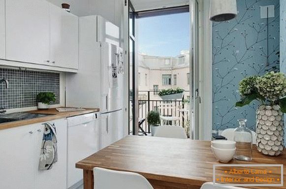Küche mit Balkon in einer Einzimmerwohnung im skandinavischen Stil