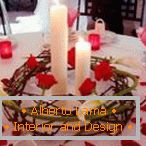 Dekoration einer Tabelle mit Kerzen und rosafarbenen Blumenblättern
