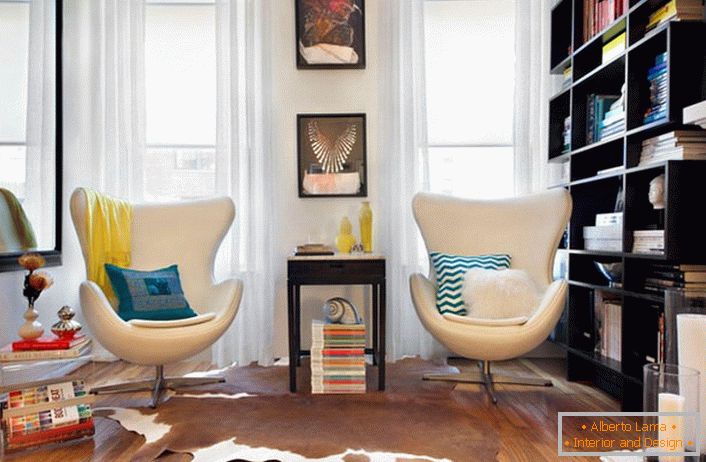 Exotische Sessel von ungewöhnlicher Form im Stil des Eklektizismus. Regale mit vielen Büchern in der Ecke für einen begeisterten Leser. 